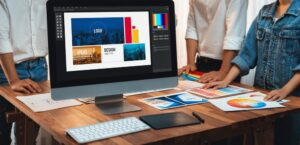 a group of graphic designers working around a computer